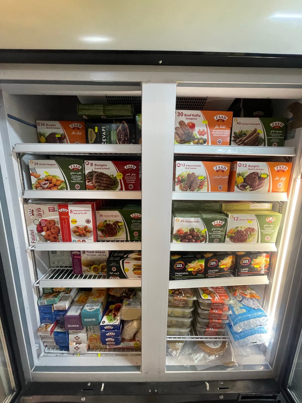 Chest freezers of frozen burgers, kofta and vegetables