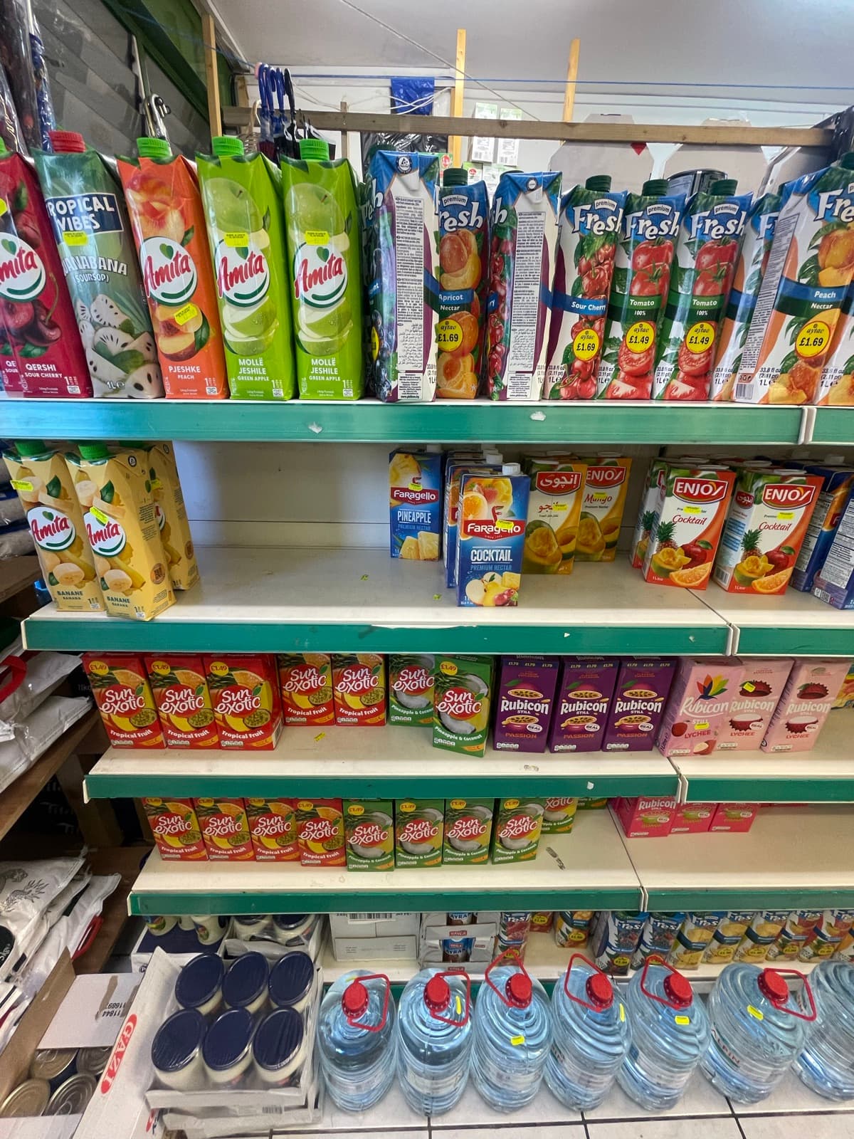 Shelves of juice cartons and soft drinks