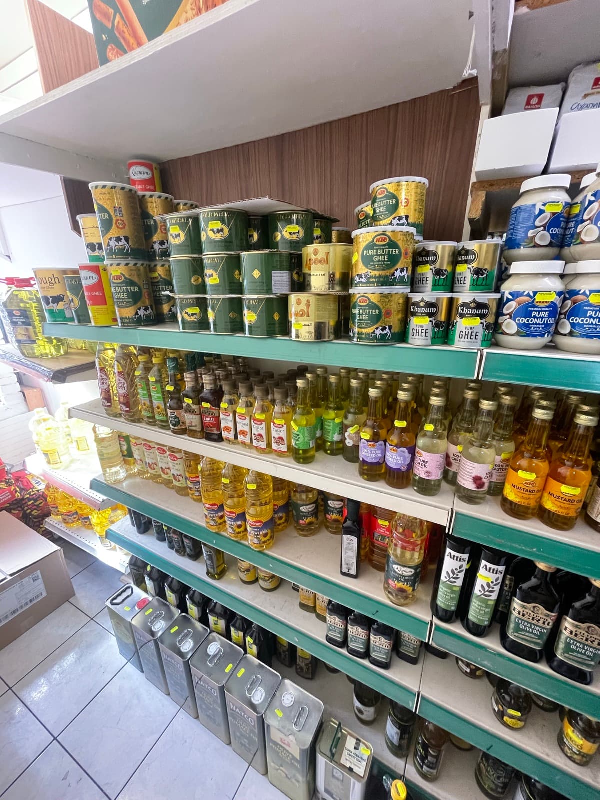 Shelves of cooking oils and vinegar bottles