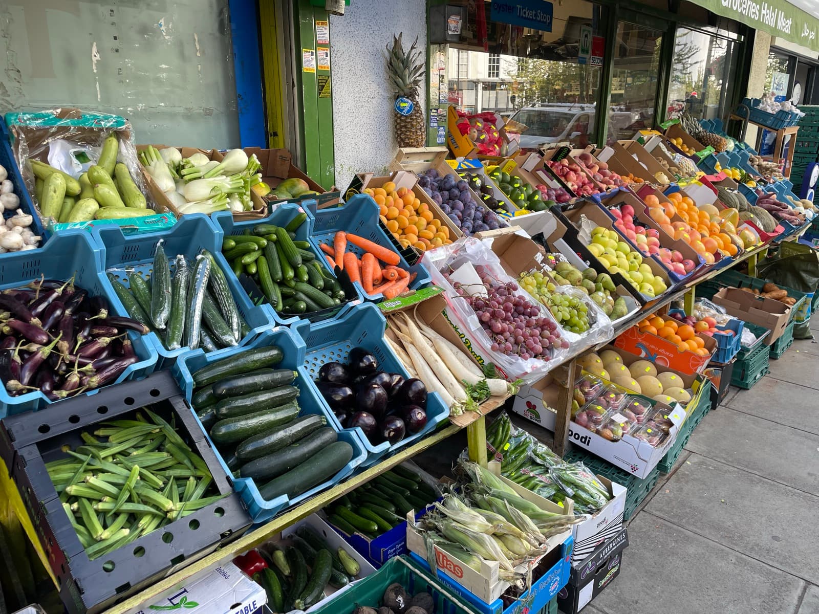 Crates of vegetables and fruit on the street display outside the shop